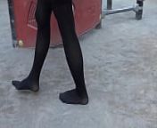 Girl walks on the sand in the park in black tights from arena and park both dance