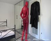 Red leather hooded wife in handcuffs and chains from wellies and leather leggings in mud